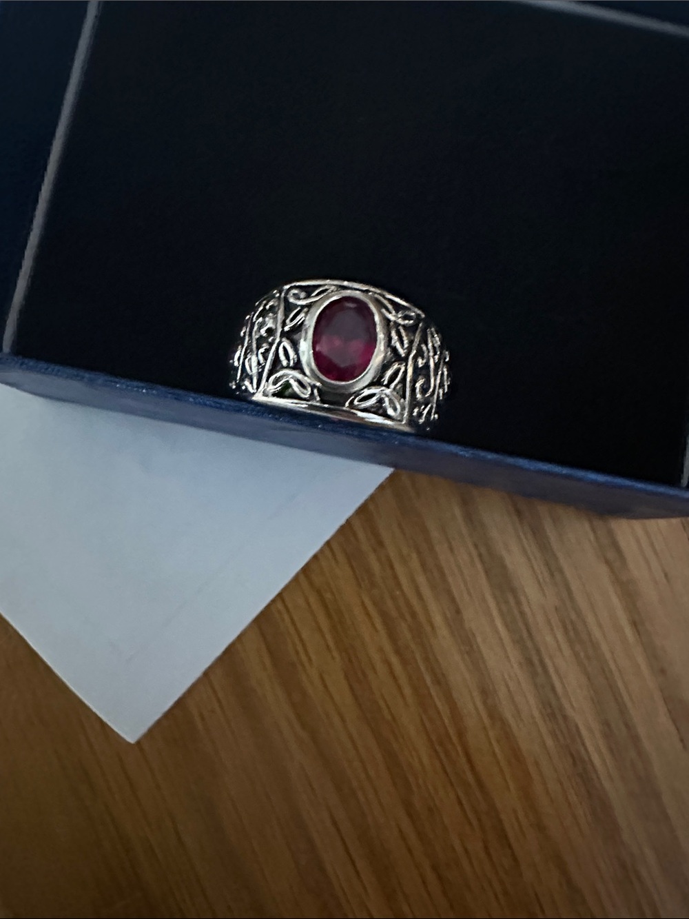 Ornate Silver Ring with Deep Red Oval Gem